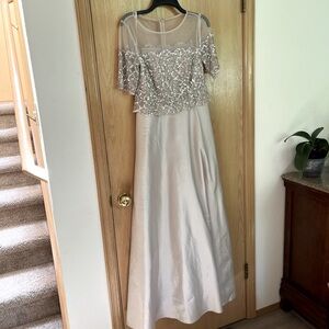 Elegant evening gown. Sheer top. Floor length with lovely sequined bodice.